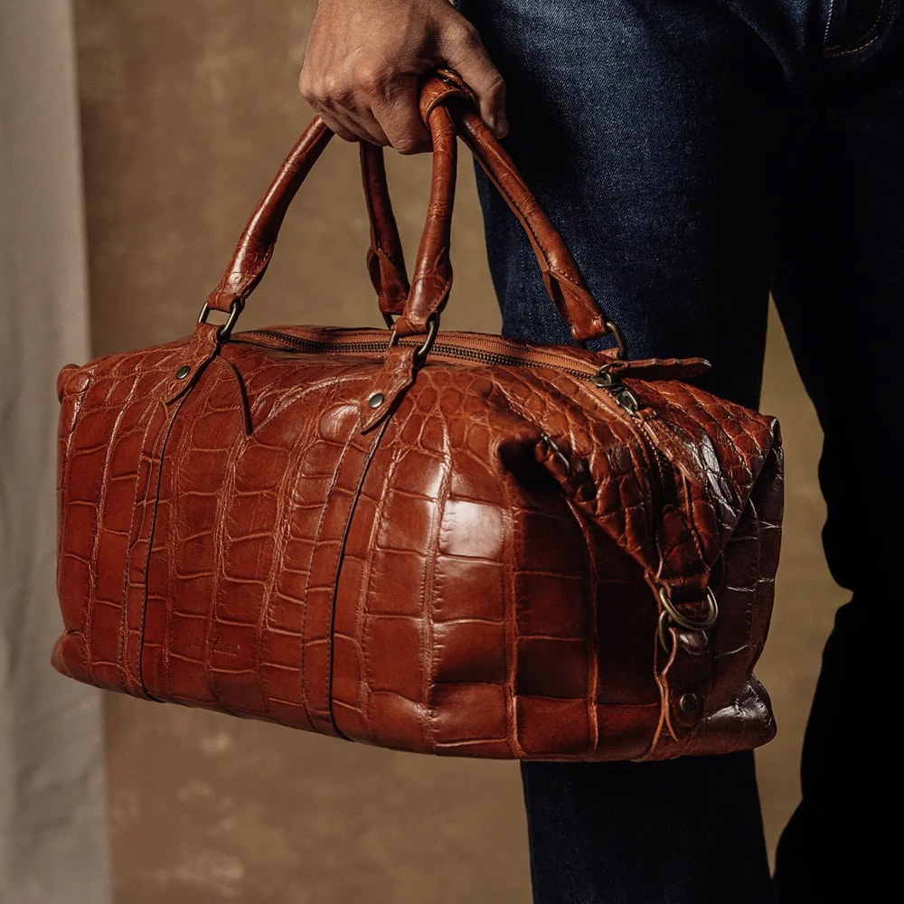 Featured Style: Alligator small duffle bag in brown. Shop the Alligator small duffle bag.