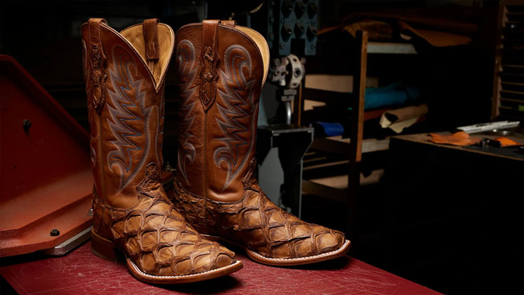 Tony Lama boots sitting a factory cutting table.