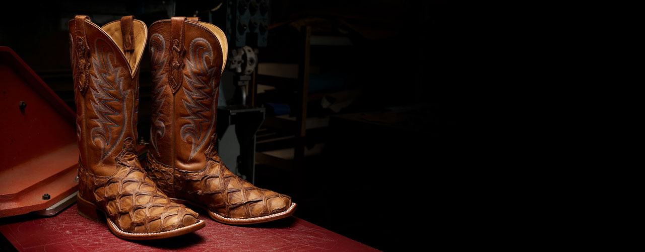 Tony Lama boots sitting a factory cutting table.